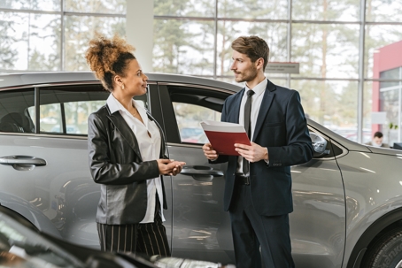 car buyer with salesperson in dealership